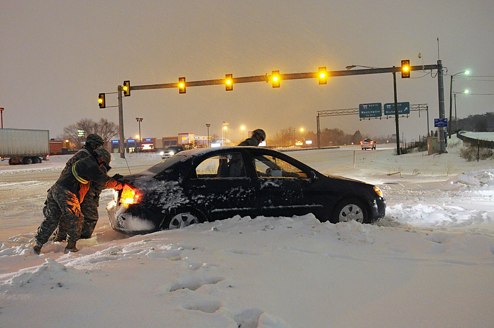 Virginia National Guard Soldiers from the Fredericksburg-based 116th Brigade Special Troops Battalion, 116th Brigade Combat Team perform health and welfare checks of abandoned and stranded vehicles during winter storm operations Feb. 13, 2014. More than 200 Va. Guard personnel were staged across the Commonwealth and ready to rapidly respond if needed by Virginia State Police or local emergency response organizations. Across the nation, Soldiers and Airmen responded to assist their local communities.