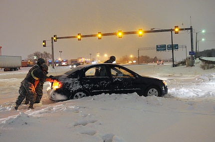 Virginia National Guard Soldiers from the Fredericksburg-based 116th Brigade Special Troops Battalion, 116th Brigade Combat Team perform health and welfare checks of abandoned and stranded vehicles during winter storm operations Feb. 13, 2014. More than 200 Va. Guard personnel were staged across the Commonwealth and ready to rapidly respond if needed by Virginia State Police or local emergency response organizations. Across the nation, Soldiers and Airmen responded to assist their local communities.