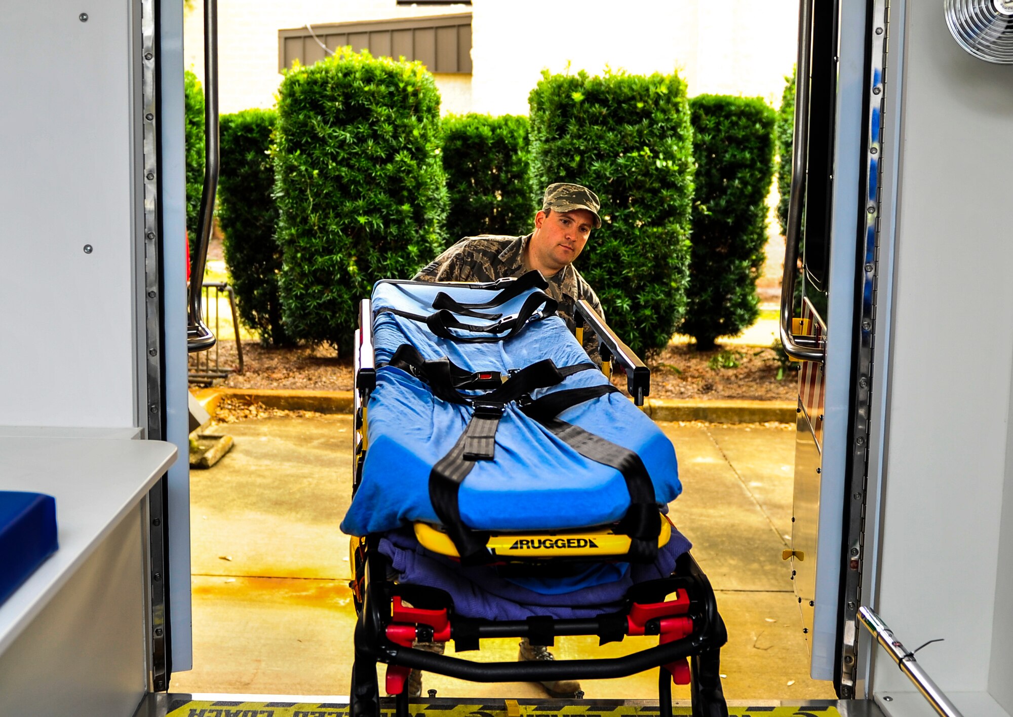 Staff Sgt. Brock Ashbaugh, 1st Special Operations Medical Operations Squadron ambulatory service paramedic, lifts a gurney onto an ambulance on Hurlburt Field, Fla., Dec. 30, 2014. The 1st SOMDOS is upgrading their fleet of ambulances and is scheduled to receive a total of three new vehicles.  (U.S. Air Force photo/Senior Airman Christopher Callaway)  