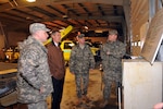 U.S. Sen. Scott Brown is briefed by members of the 272nd Chemical Company of the Massachusetts National Guard on continuing sand bag production operations at the Lexington Department of Transportation site March 30, 2010. He was there visiting Guardsmen supporting Operation Rising Water. Brown is also a member of the Massachusetts National Guard.