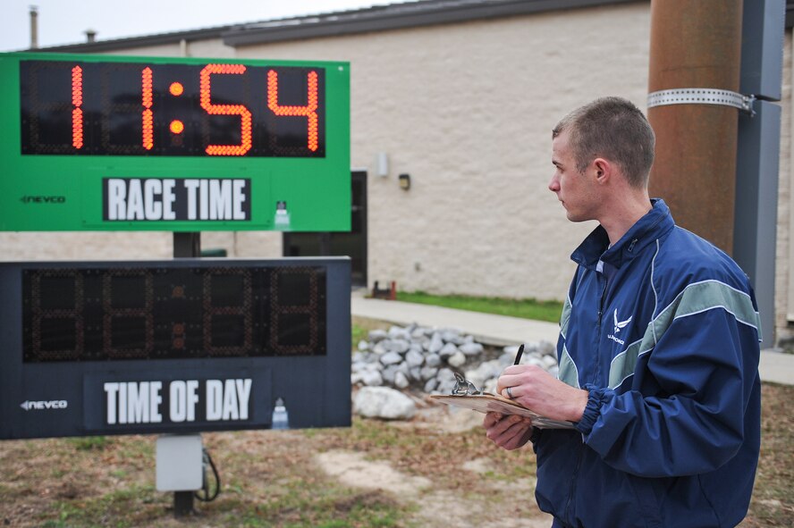 Senior Airman Andrew Muhlhahn, Fitness Assessment Cell augmentee, records runtimes during the cardio portion of the fitness assessment at the Aderholt Fitness Center on Hurlburt Field, Fla., Dec. 31, 2014. FAC augmentees are charged to uphold the standards of the Air Force Fitness Assessment in accordance with Air Force Instruction 36-2905 Chapter 3. (U.S. Air Force photo/Airman 1st Class Jeff Parkinson)
