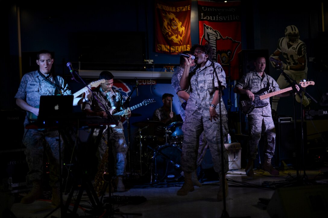 U.S. Air Force Central Command’s band, Hypersonic, performs for members of the 386th Air Expeditionary Wing May 3, 2014, in Southwest Asia. The band spent four days touring the region, performing for deployed troops to boost morale and reaching out to host nation communities. The band is deployed from Yokota Air Base, Japan. (U.S. Air Force photo/Staff Sgt. Jeremy Bowcock)