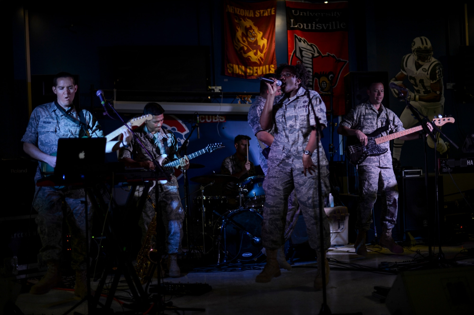 U.S. Air Force Central Command’s band, Hypersonic, performs for members of the 386th Air Expeditionary Wing May 3, 2014, in Southwest Asia. The band spent four days touring the region, performing for deployed troops to boost morale and reaching out to host nation communities. The band is deployed from Yokota Air Base, Japan. (U.S. Air Force photo/Staff Sgt. Jeremy Bowcock)