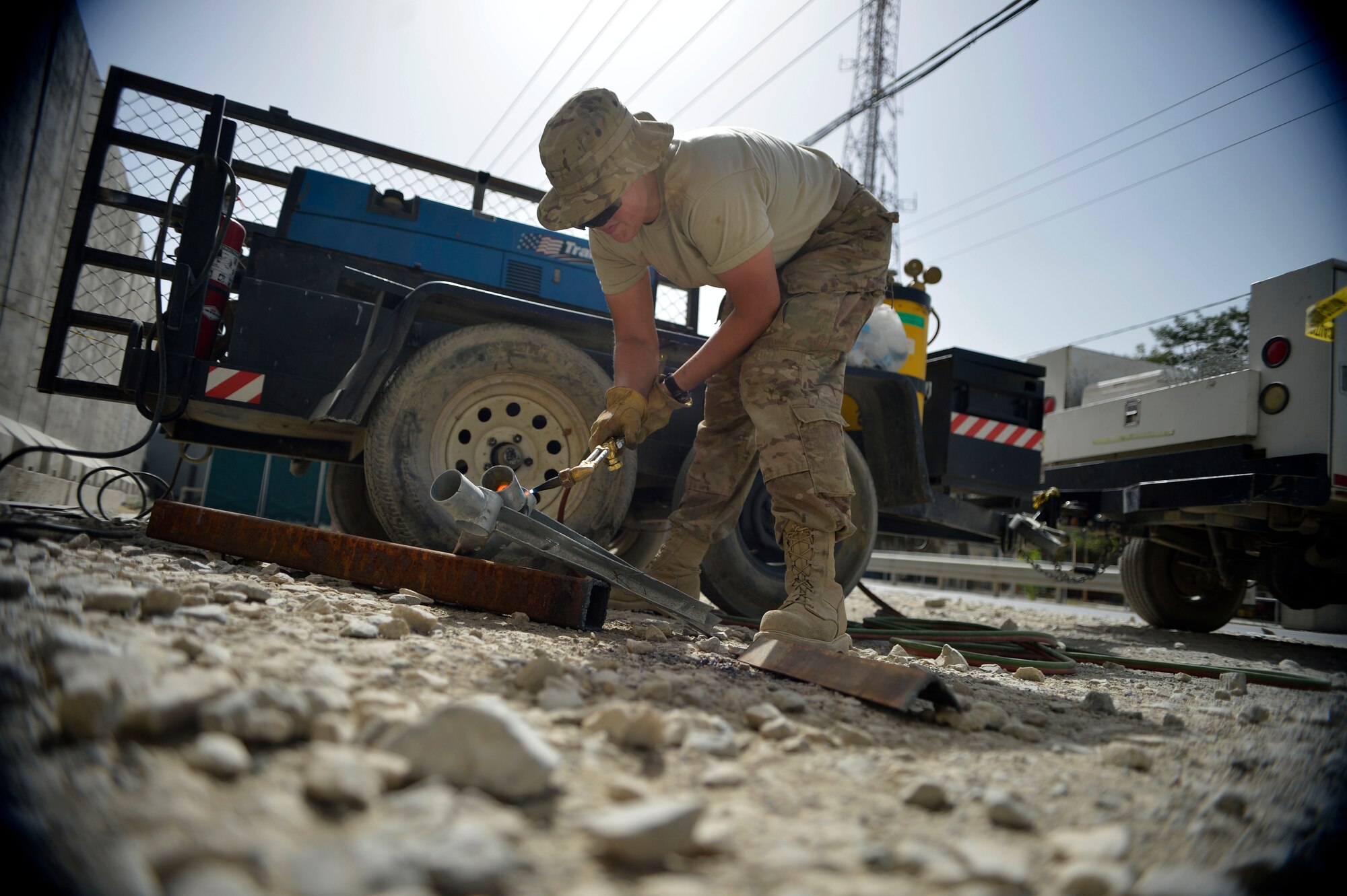 Staff Sgt. Samantha Orem welds parts for a fence Sept. 19, 2014, at Bagram Airfield, Afghanistan.  Airmen with the 455th Expeditionary Civil Engineer Squadron are completing a security fence project.  Orem is a 455th ECES structures craftsman. (U.S. Air Force photo/Staff Sgt. Evelyn Chavez)