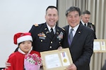 DONGDUCHEON, South Korea (Dec. 23, 2014) - Lt. Col. Don Potoczny, the commander of 1st Battalion, 38th Field Artillery Regiment, 210th Field Artillery Brigade, 2nd Infantry Division, receives an award from Mayor Oh Se-chang of Dongducheon, for his service in the local High-Five English program at Dongducheon Yangju Office of Education.  (U.S. Army photo by Cpl. Song Gun-woo, 210 FA BDE PAO)