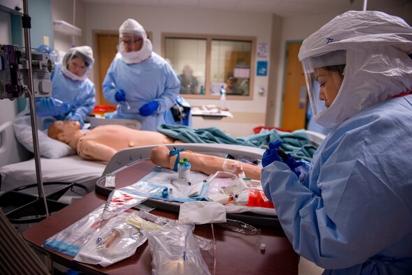 Capt. Tanya Tsosie draws blood from a simulated Ebola patient Oct. 24, 2014, during a week-long training course at the San Antonio Military Medical Center, Texas. Tsosie is a nurse assigned to a 30-member medical response team designed to support civilian medical professionals in the event of an Ebola outbreak in the United States. (U.S. Air Force photo/Master Sgt. Jeffrey Allen)