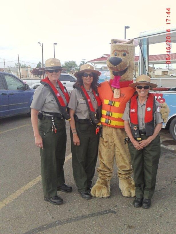 2014 District Photo Drive entry. Photo by Michael Vollmer, May 16, 2014.  “Conchas Dam Lead Park Ranger Valerie Mavis (right) and Seasonal Rangers Ricky Haralson (far left) and Nadine Carter (2nd from left) assist volunteer Mathew Pacheco (Bobber) with a water safety event in Tucumcari, N.M.”