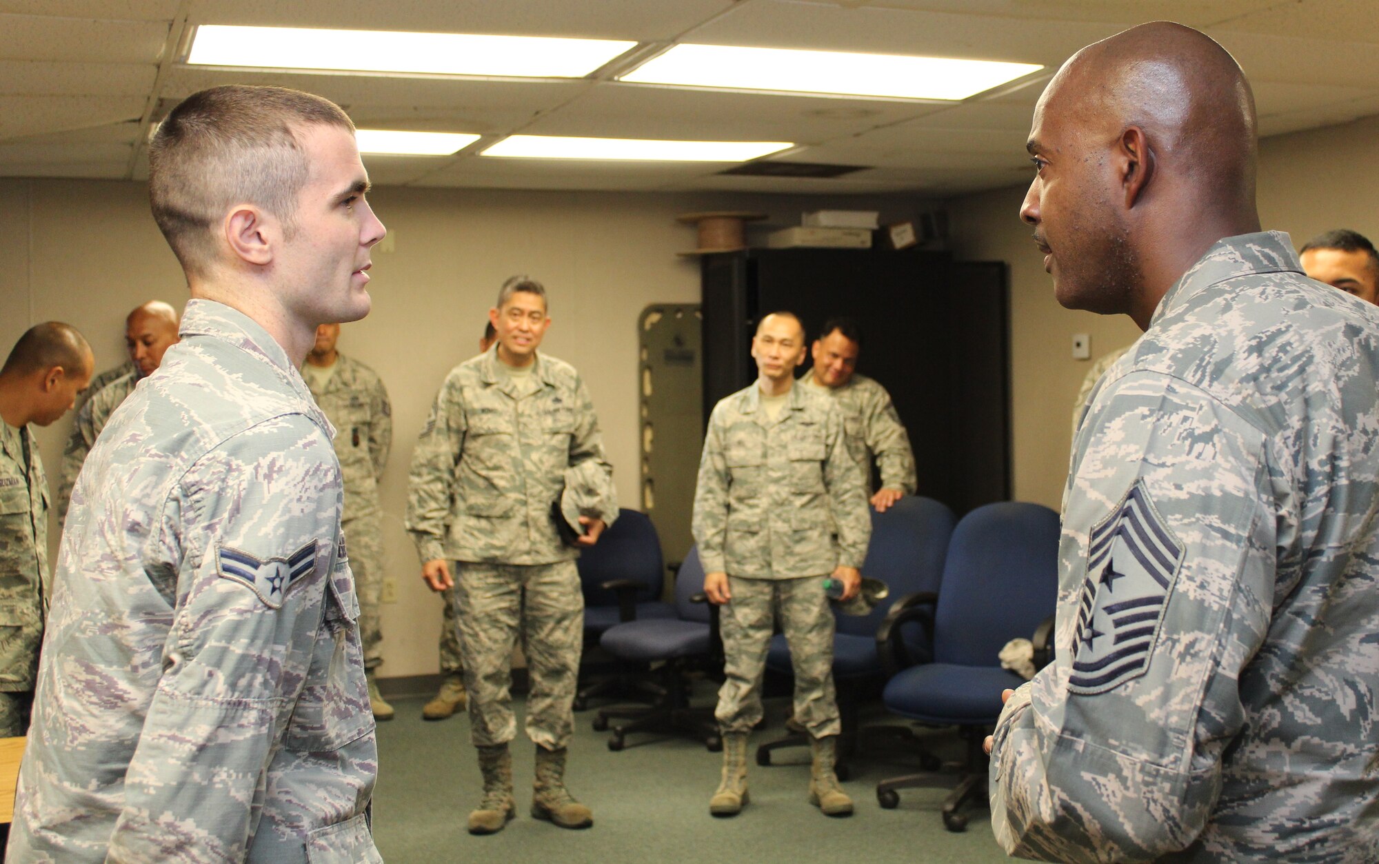 Chief Master Sgt. Cameron Kirksey, right, command chief of Air Force Reserve Command, Robins Air Force Base, Georgia, speaks to Airman 1st Class Davyn Thornburg, left, a firefighter with the 624th Civil Engineering Squadron, Joint Base Pearl Harbor-Hickam, Hawaii, during an informal mentoring session at Hickam Field, Dec. 6, 2014. Kirksey toured the unit at Hickam Field to thank the Airmen for their service and to field their questions and concerns to take back to headquarters. (U.S. Air Force photo by Master Sgt. Cris Ildefonso)