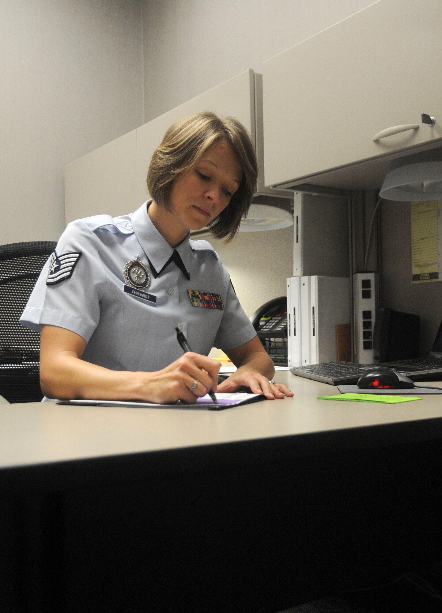 Tech Sgt. Mandy Denhardt, Arkansas Air National Guard recruiter, works at her desk at Ebbing Air National Guard Base, Fort Smith, Ark., Dec. 6, 2014. Denhardt was selected for The Flying Razorback spotlight for the month of January. (U.S. Air National Guard photo by Airman 1st Class Cody Martin/released)