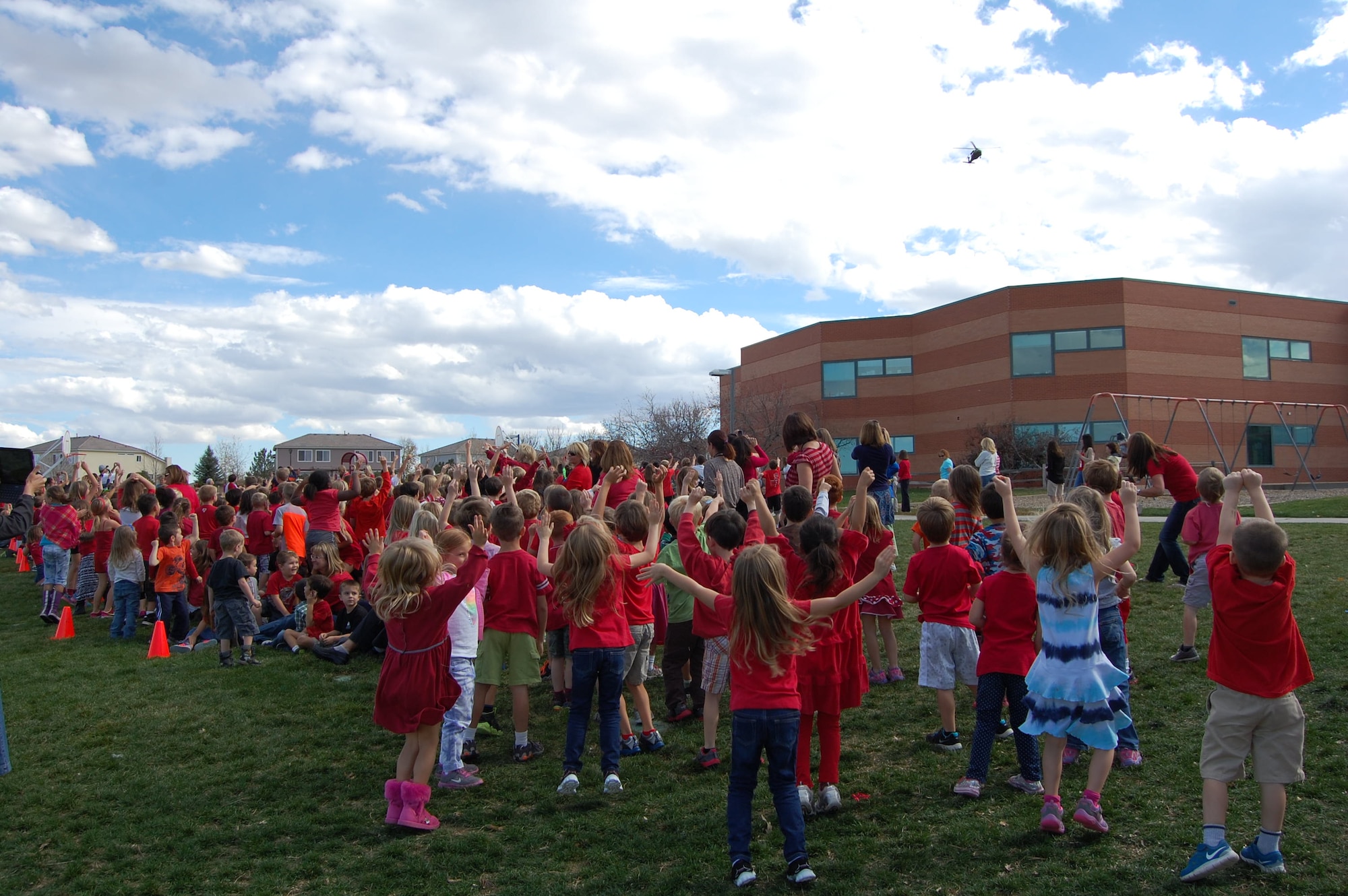 Children attending Summit View Elementary School, Littleton, Colo., help wave in the Blackhawk helicopter coming to visit during their Red Ribbon Week October 21, 2014. Members of the Colorado Joint Counterdrug Task Force and Drug Enforcement Agency flew into the schoolyard to talk with the children about making good choices to stay healthy and drug free. (U.S. Air National Guard photo by Capt. Kinder Blacke)