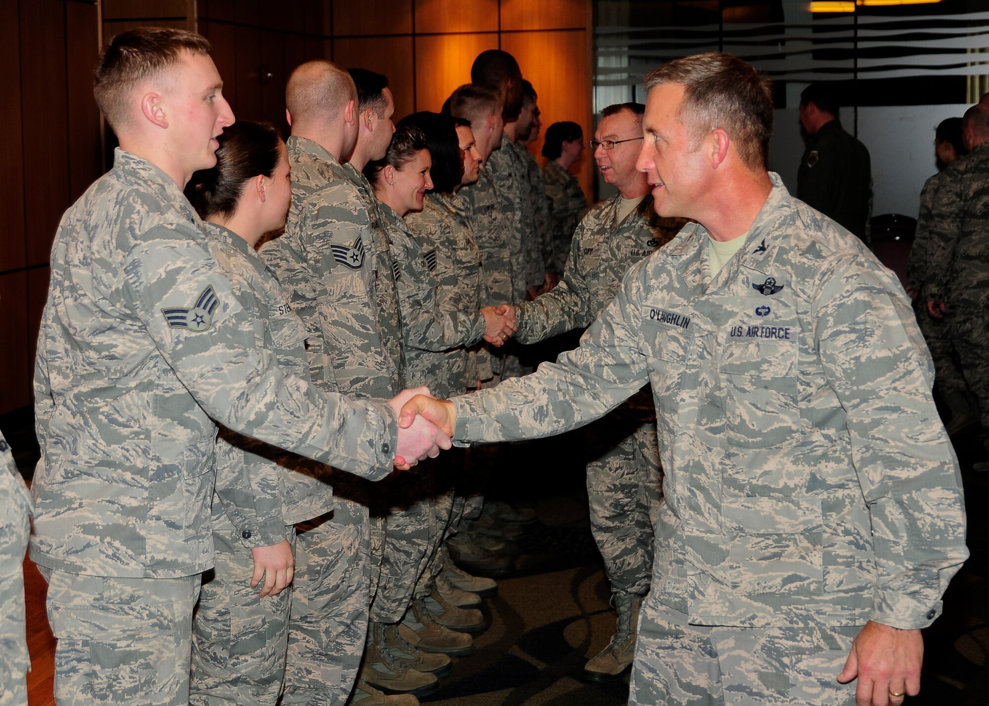 Colonel Mark O’Laughlin, 325th Fighter Wing vice commander, shakes the hands of Tyndall’s newest promotees after the January Promotion Ceremony Dec. 30 at the Horizon’s Ballroom. The monthly promotion ceremony honors those Airmen receiving a new rank. (U.S. Air Force photo by Airman 1st Class Solomon Cook)