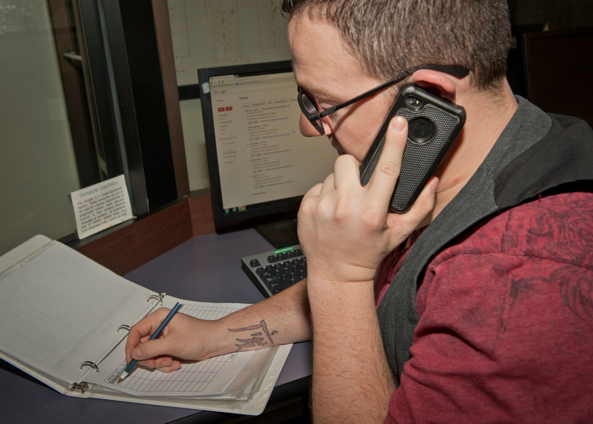PETERSON AIR FORCE BASE, Colo. – Staff Sgt. Jefrey Davis, Airmen Against Drunk Driving president and shift lead for the weekend, writes down the information he gets from a caller Dec. 27 to make sure they can get picked up as efficiently as possible. A2D2 operates at the Eclipse Café and is an Airmen-run organization that assists military members, their family members and civilian employees who have been drinking and need a ride to get home safely. Those requesting A2D2 services need only call and provide their first name, phone number, their location and number of passengers. (U.S. Air Force photo by Airman 1st Class Rose Gudex)