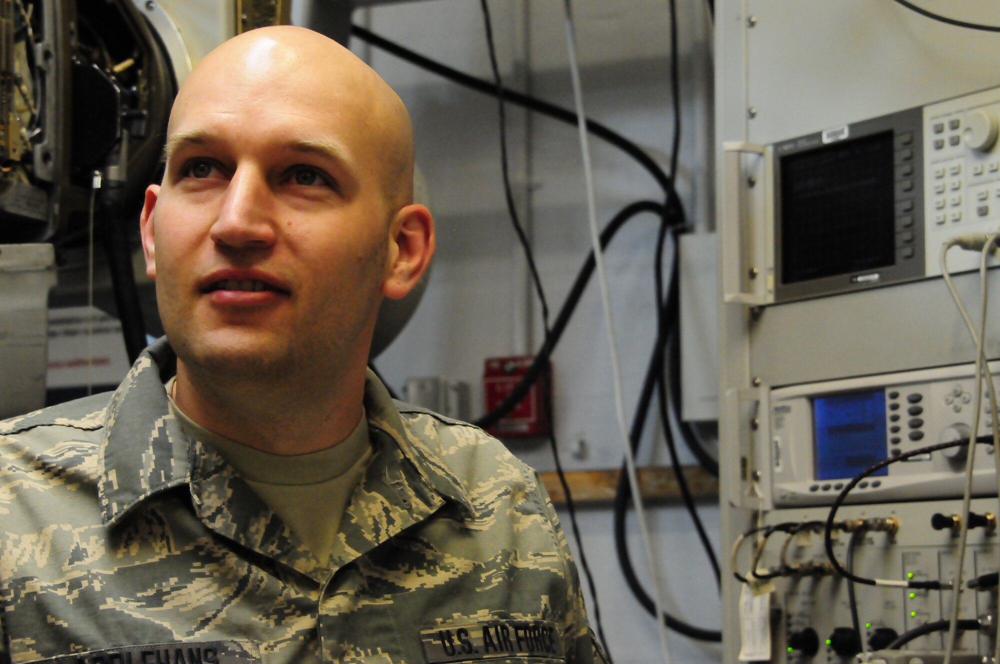 Tech Sgt. Matthew Applehans, Electronic Warfare Systems Craftsman, 140th Maintenance Group, discusses the intricacies of the electronic counter measure pod. (U.S. Air National Guard Photo by Staff Sgt. Nicole Manzanares)