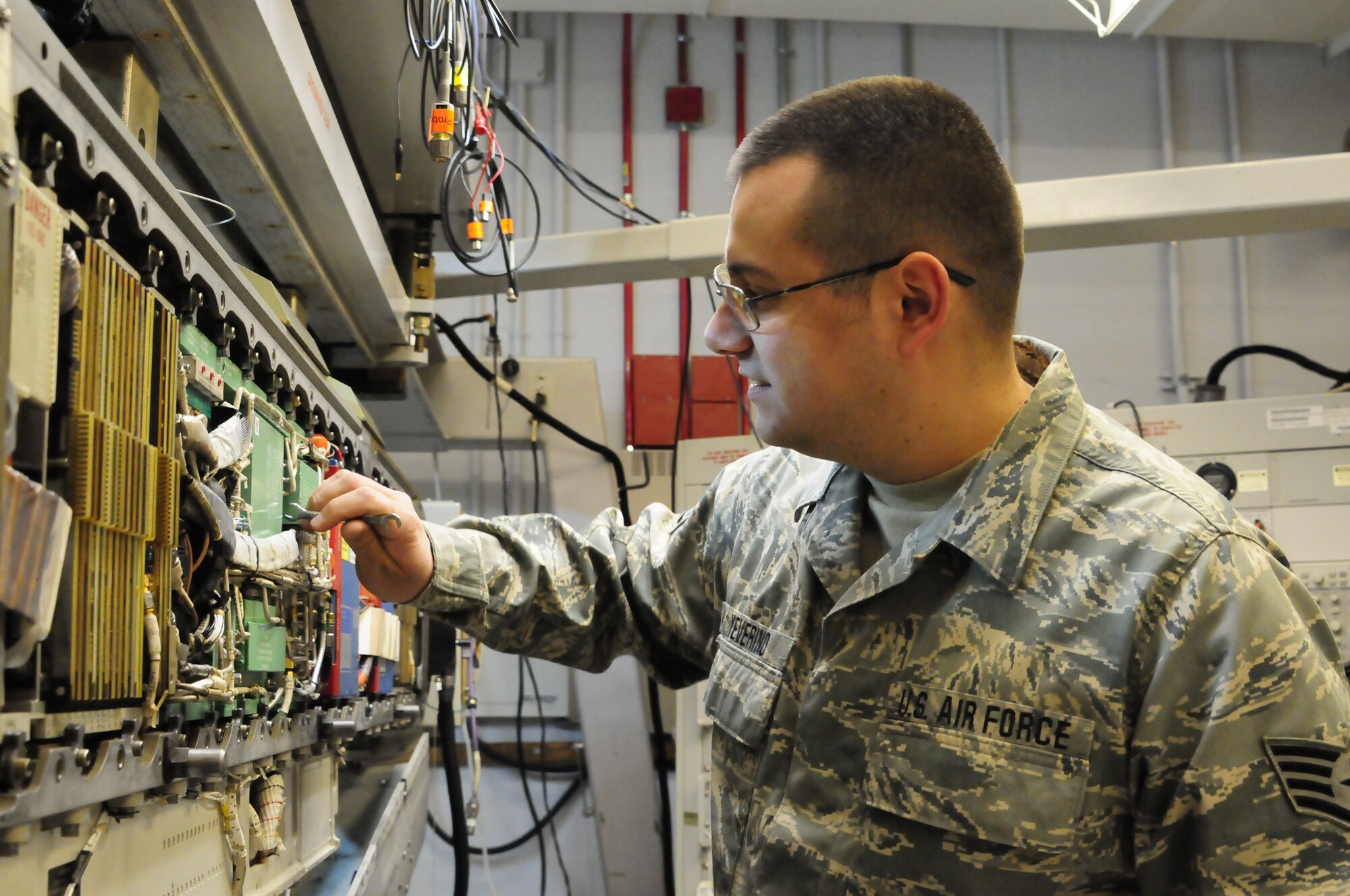 Staff Sgt. Robert Yeverino, 140th Maintenance Group, Electronic Warfare Systems Craftsman, performs a quality assurance inspection; double checking connections to ensure an efficient electronic counter measure pod. (U.S. Air National Guard Photo by Staff Sgt. Nicole Manzanares)