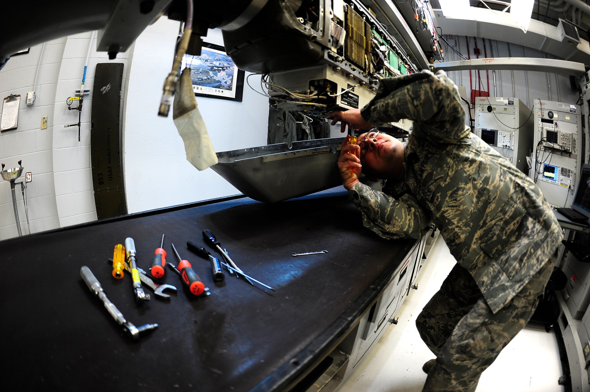 Staff Sgt. Robert Yeverino, 140th Maintenance Group, Electronic Warfare Systems Craftsman, performs a quality assurance inspection; double checking connections to ensure an efficient electronic counter measure pod. (U.S. Air National Guard Photo by Staff Sgt. Nicole Manzanares)