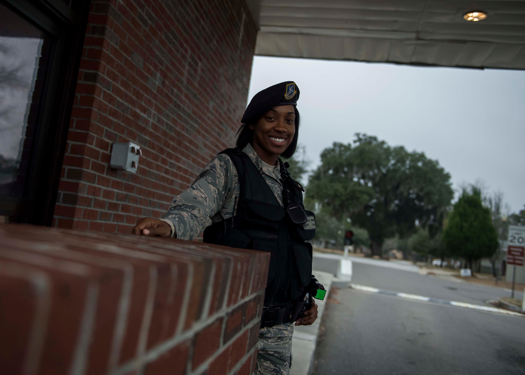 Staff Sgt. Natasha Bouie, 628th Security Forces Squadron swings flight chief, smiles while standing her post at the Hunley Park Gate, Dec. 30, 2014, at Joint Base Charleston S.C. The 628th SFS defends all assets and personnel on JB Charleston, even during the holiday season when many Airmen and Sailors are taking time off. During the holidays, SFS forces switch to 12-hour shifts instead of their usual eight, and divide their duties into two elements to allow their personnel time off for the holidays. One element works the week of Christmas and the other element works the week of New Years. (U.S. Air Force photo/Senior Airman Jared Trimarchi) 
 
