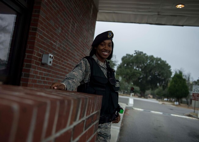 Staff Sgt. Natasha Bouie, 628th Security Forces Squadron swings flight chief, smiles while standing her post at the Hunley Park Gate, Dec. 30, 2014, at Joint Base Charleston S.C. The 628th SFS defends all assets and personnel on JB Charleston, even during the holiday season when many Airmen and Sailors are taking time off. During the holidays, SFS forces switch to 12-hour shifts instead of their usual eight, and divide their duties into two elements to allow their personnel time off for the holidays. One element works the week of Christmas and the other element works the week of New Years. (U.S. Air Force photo/Senior Airman Jared Trimarchi) 
 
