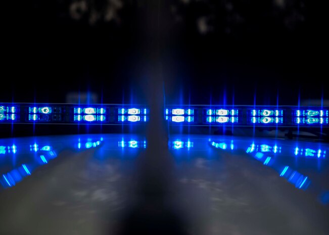 A 628th Security Forces patrol vehicle flashes blue lights Dec. 30, 2014, at Joint Base Charleston S.C. The 628th SFS defends all assets and personnel on JB Charleston, even during the holiday season when many Airmen and Sailors are taking time off. During the holidays, SFS forces switch to 12-hour shifts instead of their usual eight, and divide their duties into two elements to allow their personnel some time off for the holidays. One element works the week of Christmas and the other element works the week of New Years.  (U.S. Air Force photo/Senior Airman Jared Trimarchi) 
 
