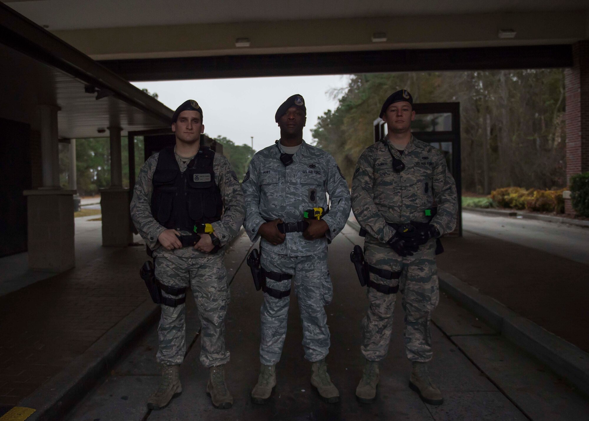 Airman 1st Class Hunter Banks, 628th Security Forces Squadron installation entry controller, Tech. Sgt. Dwayne Hurt, 628th SFS swings flight chief, and Airman 1st Class Justin Colmer, 628th SFS installation entry controller, stand ready at the Dorchester gate, Dec. 30, 2014, at Joint Base Charleston S.C. The 628th SFS defends all assets and personnel on JB Charleston, even during the holiday season when many Airmen and Sailors are taking time off. During the holidays, SFS forces switch to 12-hour shifts instead of their usual eight, and divide their duties into two elements to allow their personnel time off for the holidays. One element works the week of Christmas and the other element works the week of New Years. (U.S. Air Force photo/Senior Airman Jared Trimarchi) 
 
