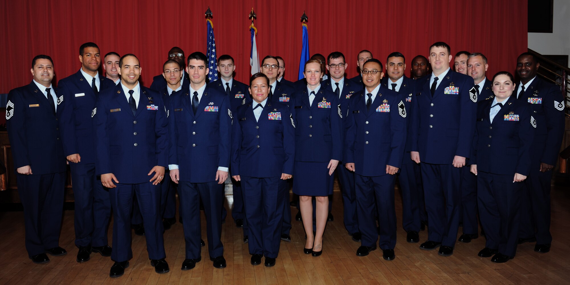 Team Mildenhall recognizes its newest promotees Dec. 31, 2014, at the Galaxy Club, on RAF Mildenhall, England. Each month, Team Mildenhall holds a promotion ceremony for those moving up the ranks to staff sergeant through chief master sergeant. (U.S. Air Force photo by Senior Airman Preston Webb/Released)