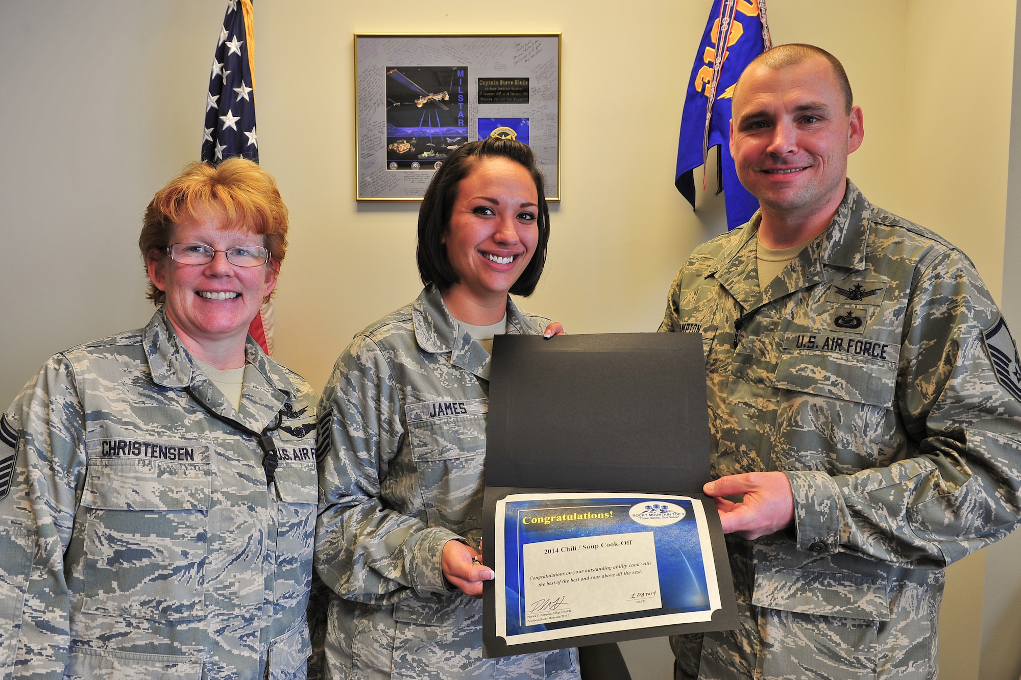 Air Force Reserve Tech. Sgt. Jessica James (center) is awarded first place in the 310th Space Wing Top-3 chili and soup cook-off Feb. 1, 2014, at Schriever Air Force Base, Colo. Senior Master Sgt. Lisa Christensen, along with Master Sgt. Patrick Hampton, awarded James a certificate and a $25 gift card. James won with her "Pueblo Green Chili". The cook-off was held to raise money for the 310th SW annual awards banquet, with $240 raised. The Top-3 is an association of senior non-commissioned officers that promote military professionalism, development and quality of life for all enlisted personnel. (U.S. Air Force photo/Tech. Sgt. Nicholas B. Ontiveros)