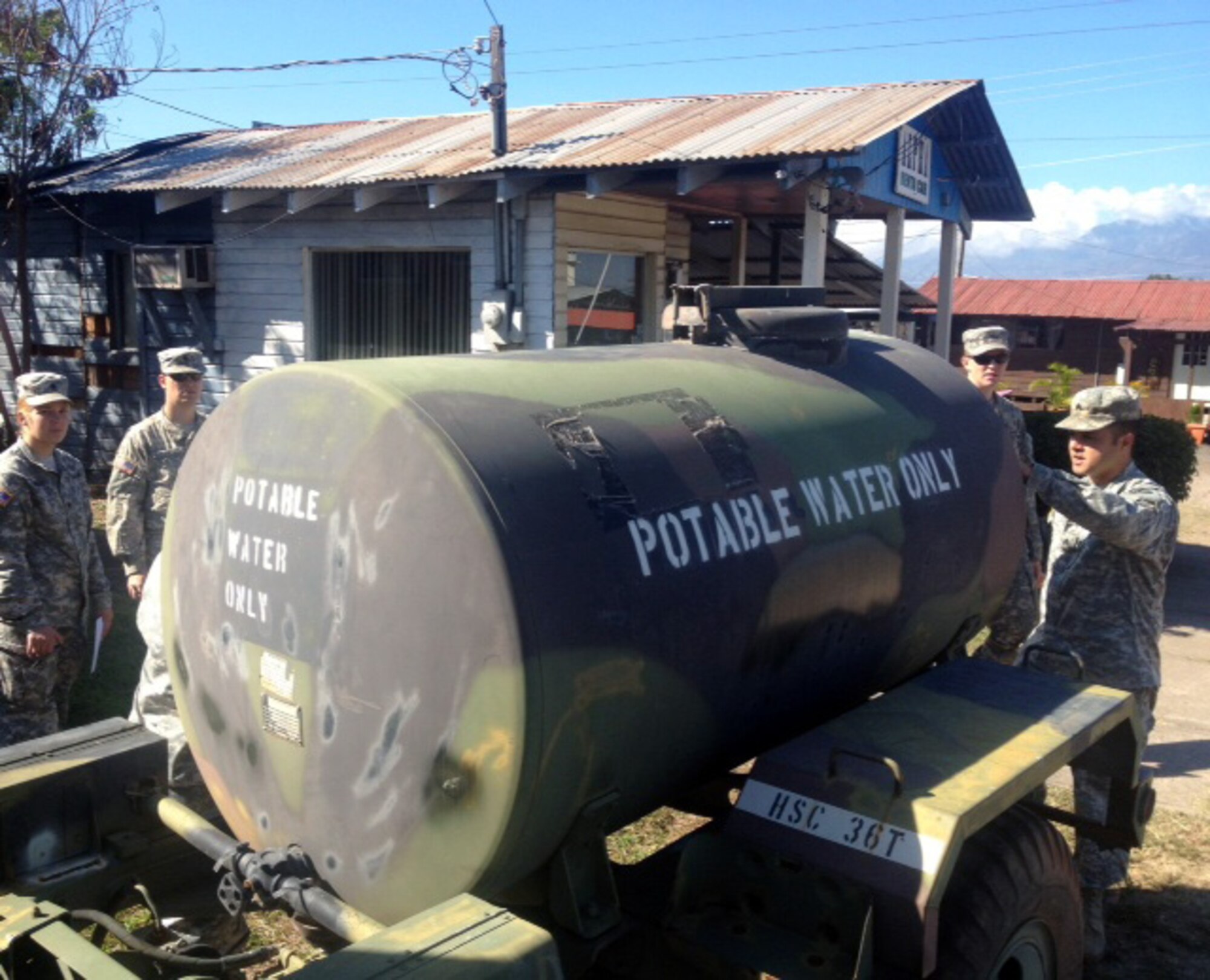 Joint Task Force-Bravo members practice inspecting, cleaning and filling a 400 gallon water trailer during a field sanitation team (FST) certification course at Soto Cano Air Base, Honduras, Jan. 30, 2014.  Twenty-five members of the Task Force completed the course, which covers subjects including medical threats to soldiers in the field, hygiene, preventative medicine, how to establish and maintain a water supply in the field, how food should be managed in the field and how to keep food service sanitary, insects and their diseases, rodent management, heat and cold injuries, and how to maintain control of hazardous waste.  (Courtesy photo)
