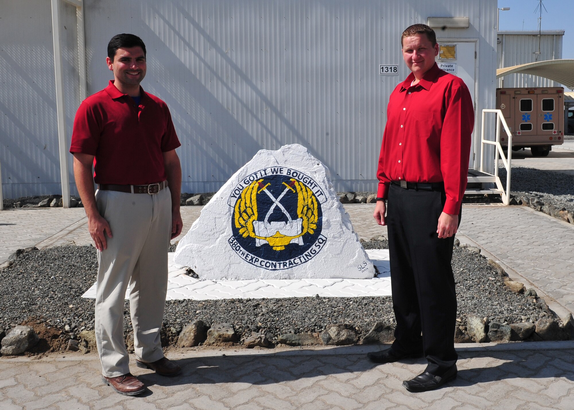 Timothy Lohn and John Seacrist both contracting specialists assigned to the 380th Expeditionary Contracting Squadron, pose for a photo. Lohn and Seacrist volunteered to deploy here to ease the frequency of deployments for military member within the critically manned contracting career field. (U.S. Air Force photo by Staff Sgt. Michael Means/Released)