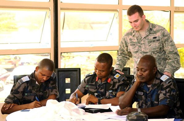 Capt. Vincent McLean takes part in a group discussion with members of the Nigerian air force for a crisis planning scenario. The Nigerian air force hosted a disaster relief planning seminar in partnership with the 621st Contingency Response Wing, U.S. Air Forces in Europe-Air Forces Africa, and U.S. Africa Command Jan. 27-30 at the National Defense College in Abuja, Nigeria. McLean is with the 621st CRW. (U.S. Air Force photo/Capt. Sybil Taunton)