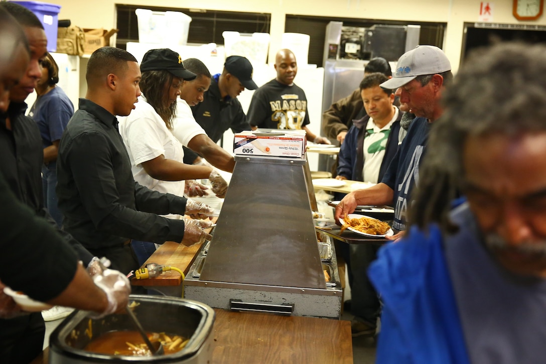 Servicemembers from Camp Pendleton and local volunteers serve food at the Bread of Life Rescue Mission in Oceanside, Calif., Jan. 28. Nine Marines and one sailor, with the help of several community volunteers, prepared and served a free dinner for local homeless and others in need at the Mission. 