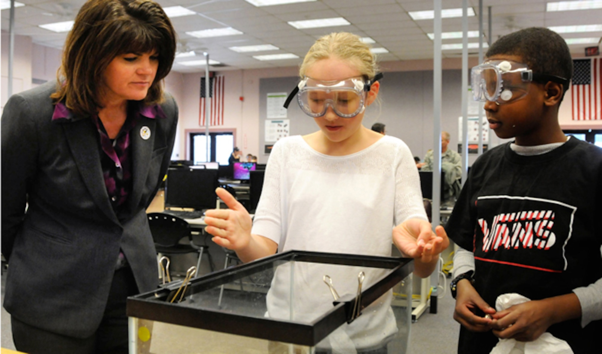 Alayna Potter (middle) and Bernard Robertson, fifth grade students from Hanscom's Primary School, explain to Dr. Mica R. Endsley the process for a Bridge Quest Activity Jan. 24, 2014, at Hanscom Air Force Base, Mass. The students participate in STARBASE Academy, a DOD-initiative to get youth interested in science, technology, engineering and math. Endsley is the chief scientist of the Air Force and visited Hanscom AFB to receive briefings about programs, learn about development planning work and visit STARBASE. (U.S. Air Force photo/Linda LaBonte Britt)