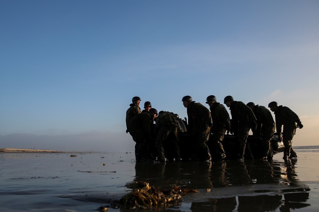 Soldiers with the Japan Ground Self-Defense Force carry a combat rubber reconnaissance craft out of the surf during amphibious-insertion training from the Expeditionary Warfare Training Group Pacific during Exercise Iron Fist 2014 aboard Naval Amphibious Base Coronado, Calif., Jan. 29, 2014. Iron Fist is an amphibious exercise that brings together Marines and sailors from the 15th Marine Expeditionary Unit, other I Marine Expeditionary Force units, and soldiers from the JGSDF, to promote military interoperability and hone individual and small-unit skills through challenging, complex and realistic training. (U.S. Marine Corps photo by Cpl. Emmanuel Ramos/Released)
