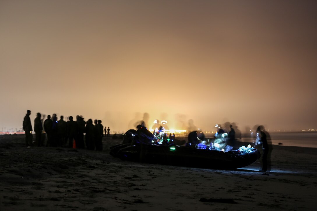 Soldiers with the Japan Ground Self-Defense Force make final adjustments to the combat rubber reconnaissance craft before a night amphibious insertion during Exercise Iron Fist 2014 aboard Naval Amphibious Base Coronado, Calif., Jan. 29, 2014. Iron Fist is an amphibious exercise that brings together Marines and sailors from the 15th Marine Expeditionary Unit, other I Marine Expeditionary Force units, and soldiers from the JGSDF, to promote military interoperability and hone individual and small-unit skills through challenging, complex and realistic training. (U.S. Marine Corps photo by Cpl. Emmanuel Ramos/Released)