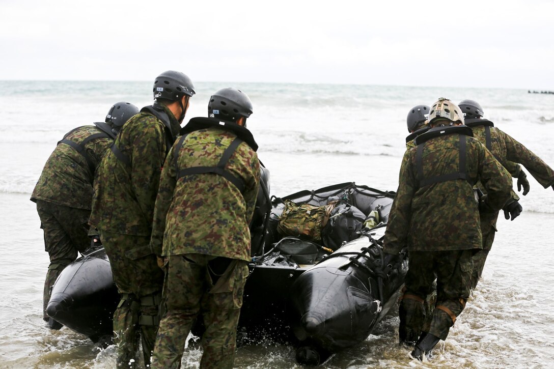 Soldiers with the Japan Ground Self-Defense Force carry a Combat Rubber Reconnaissance Craft into the ocean to conduct surf passages as part of reconnaissance training with the Expeditionary Warfare Training Group Pacific during Exercise Iron Fist 2014 aboard Naval Amphibious Base Coronado, Calif., Jan. 30, 2014. Iron Fist is an amphibious exercise that brings together Marines and sailors from the 15th Marine Expeditionary Unit, other I Marine Expeditionary Force units, and soldiers from the JGSDF, to promote military interoperability and hone individual and small-unit skills through challenging, complex and realistic training. (U.S. Marine Corps photo by Lance Cpl. Ricardo Hurtado/Released)