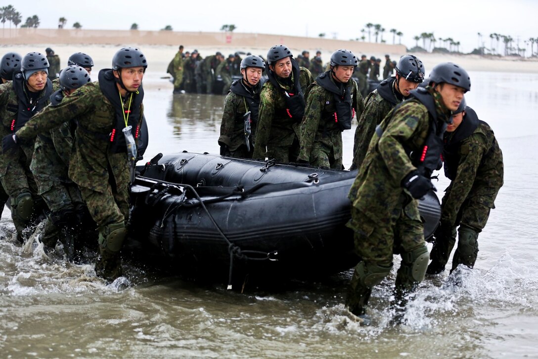 Soldiers with the Japan Ground Self-Defense Force carry a Combat Rubber Reconnaissance Craft into the ocean to conduct surf passages as part of reconnaissance training with the Expeditionary Warfare Training Group Pacific during Exercise Iron Fist 2014 aboard Naval Amphibious Base Coronado, Calif., Jan. 30, 2014. Iron Fist is an amphibious exercise that brings together Marines and sailors from the 15th Marine Expeditionary Unit, other I Marine Expeditionary Force units, and soldiers from the JGSDF, to promote military interoperability and hone individual and small-unit skills through challenging, complex and realistic training. (U.S. Marine Corps photo by Lance Cpl. Ricardo Hurtado/Released)
