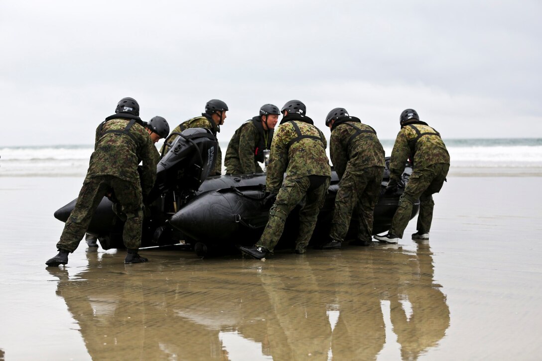 Soldiers with the Japan Ground Self-Defense Force carry a Combat Rubber Reconnaissance Craft into the ocean to conduct surf passages as part of reconnaissance training with the Expeditionary Warfare Training Group Pacific during Exercise Iron Fist 2014 aboard Naval Amphibious Base Coronado, Calif., Jan. 30, 2014. Iron Fist is an amphibious exercise that brings together Marines and sailors from the 15th Marine Expeditionary Unit, other I Marine Expeditionary Force units, and soldiers from the JGSDF, to promote military interoperability and hone individual and small-unit skills through challenging, complex and realistic training. (U.S. Marine Corps photo by Lance Cpl. Ricardo Hurtado/Released)