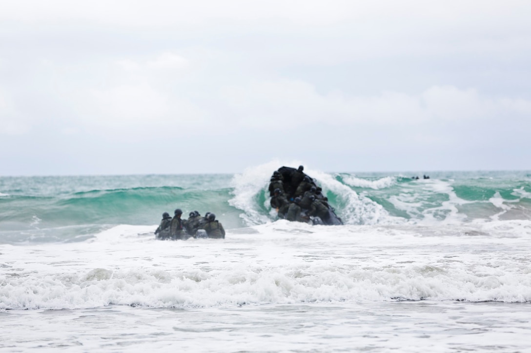 Soldiers with the Japan Ground Self-Defense Force fight waves while riding a Combat Rubber Reconnaissance Craft during surf passages as part of reconnaissance training with the Expeditionary Warfare Training Group Pacific during Exercise Iron Fist 2014 aboard Naval Amphibious Base Coronado, Calif., Jan. 30, 2014. Iron Fist is an amphibious exercise that brings together Marines and sailors from the 15th Marine Expeditionary Unit, other I Marine Expeditionary Force units, and soldiers from the JGSDF, to promote military interoperability and hone individual and small-unit skills through challenging, complex and realistic training. (U.S. Marine Corps photo by Lance Cpl. Ricardo Hurtado/Released)