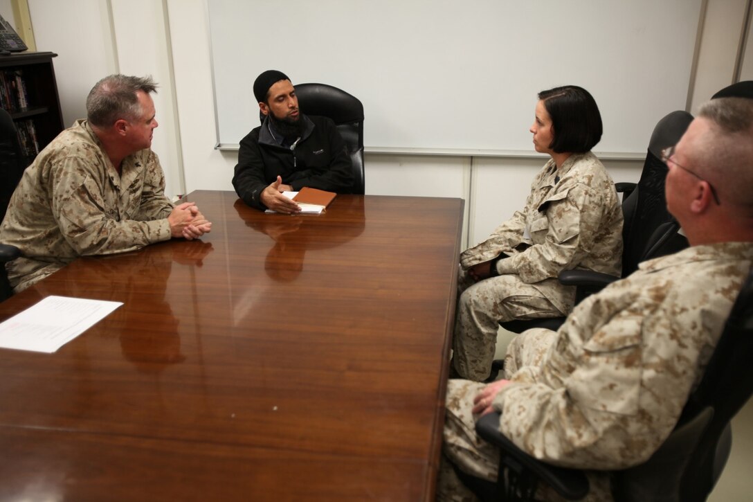 Imam Asim Hafiz, center left, an Islamic religious advisor with the British Ministry of Defence, talks to Master Sgt. Anetra Cargile, center right, spectrum management officer, Regional Command (Southwest), and a Pasadena, Texas, native. Commander Patrick Smith, left, RC(SW) chaplain, and Cmdr. Thomas Hunt, right, I Marine Expeditionary Force (Forward) chaplain, brought Muslim Marines to meet Imam Hafiz aboard Camp Leatherneck, Afghanistan, Jan. 26, 2014.