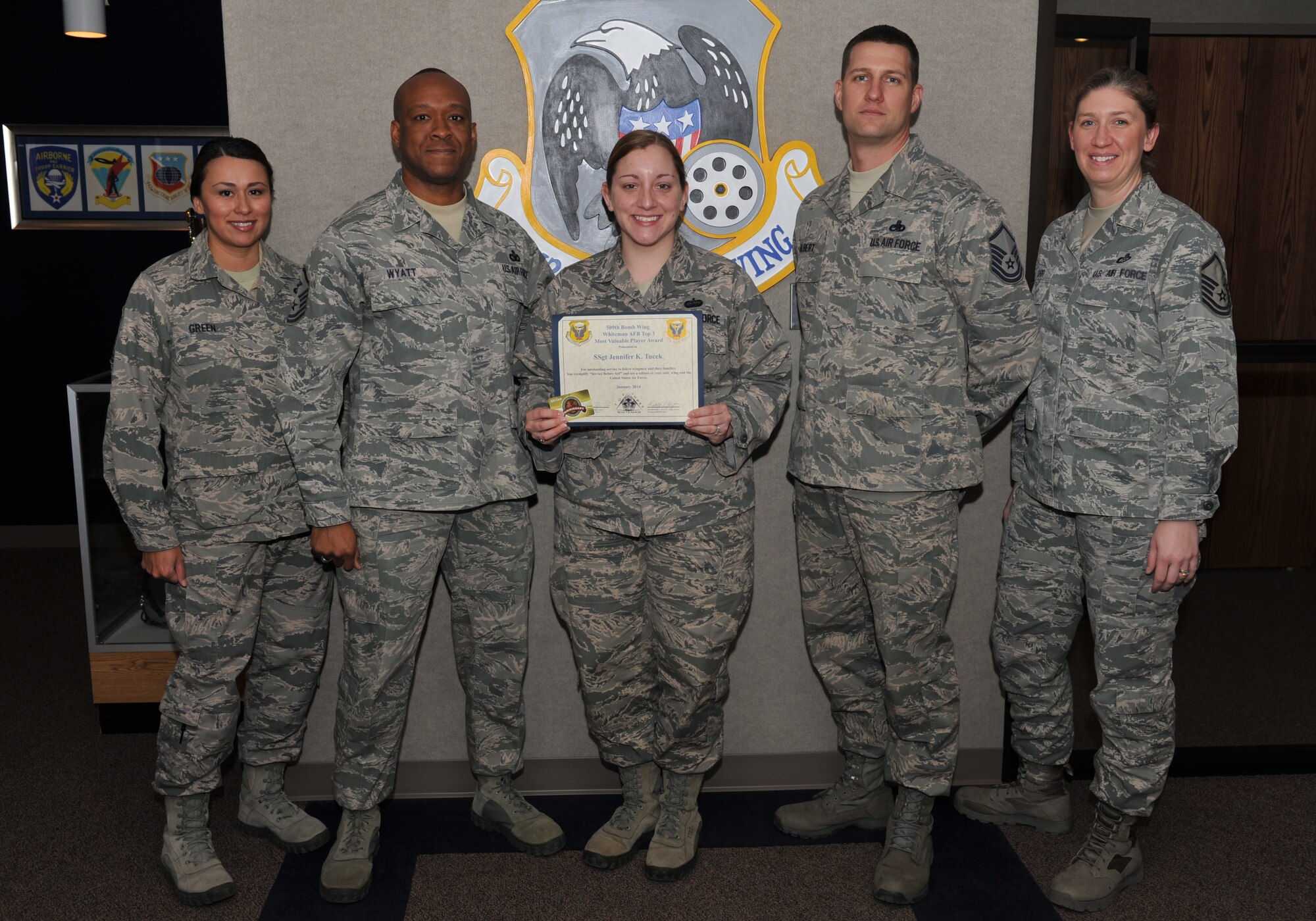 Staff Sgt. Jennifer Tucek, 495th Fighter Group (AA), Detachment 303 commander support staff, is presented with the Top III MVP Award at Whiteman Air Force Base, Mo., Jan. 24, 2013. Some accomplishments that contributed to her award include being the Spirit of America Toastmasters president, manually processing vouchers for the Army Jaded Thunder temporary duty and leading the charge for an annual total force integration party as the Det. 303 Booster Club president. (U.S. Air Force photo by Airman 1st Class Joel Pfiester/Released)