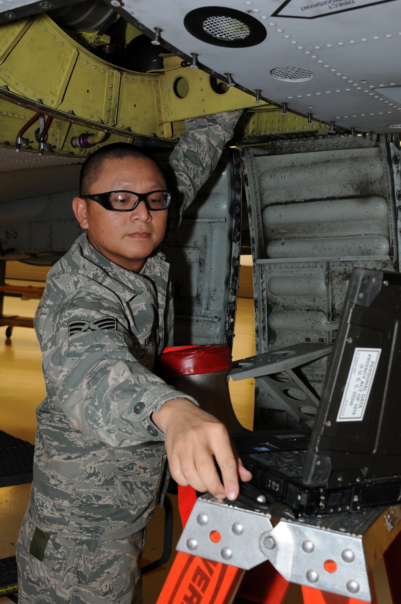 Tech. Sgt. Jacky Luong, an environment and electrical airman with the 188th Fighter Wing wraps safety wires onto environmental control system bolts on an A-10C Thunderbolt II "Warthog" at Ebbing Air National Guard Base, Fort Smith, Ark., Jan. 11, 2014. The aircraft was undergoing phase two repairs as part of its regular maintenance cycle. Luong was selected as the 188th Fighter Wing’s The Flying Razorback Spotlight for February 2014. (U.S. Air National Guard photo by Airman 1st Class Cody Martin)