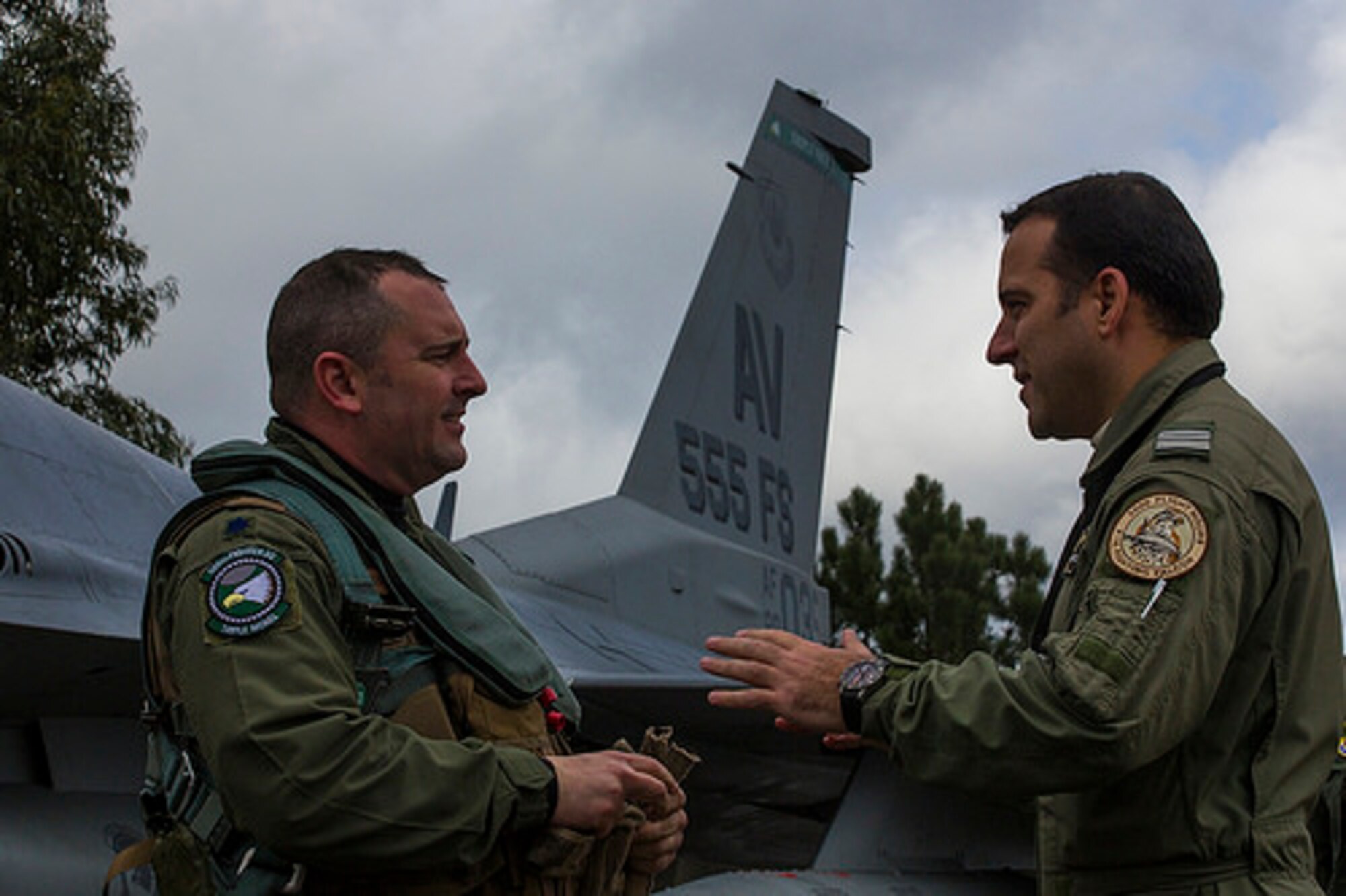Lt. Col. John Peterson, 555th Fighter Squadron commander, is greeted by Lt. Col. Charles Lawrence, exercise control cell director, following his flight to Monte Real, Portugal on Jan. 30 for REAL THAW 14. The exercise will allow pilots and maintainers from the 555th Fighter Squadron to practice working alongside NATO partners to increase interoperability and work together in a simulated wartime environment. (U.S. Air Force photo/2nd Lt. Allie Delury)