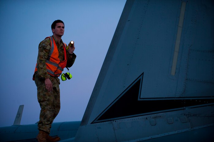 Royal Australian Air Force Lead Aircraftman Randall Costello, an armament specialist from the 77th Squadron, RAAF Base Williamtown, New South Wales, performs pre-flight checks before his assigned aircraft heads out for a night training mission during Red Flag 14-1 at Nellis Air Force Base, Nev., Jan. 30, 2014. Since its establishment in 1975, Red Flag has played host to military units from more than 30 different countries. (U.S. Air Force photo by Airman 1st Class Joshua Kleinholz)