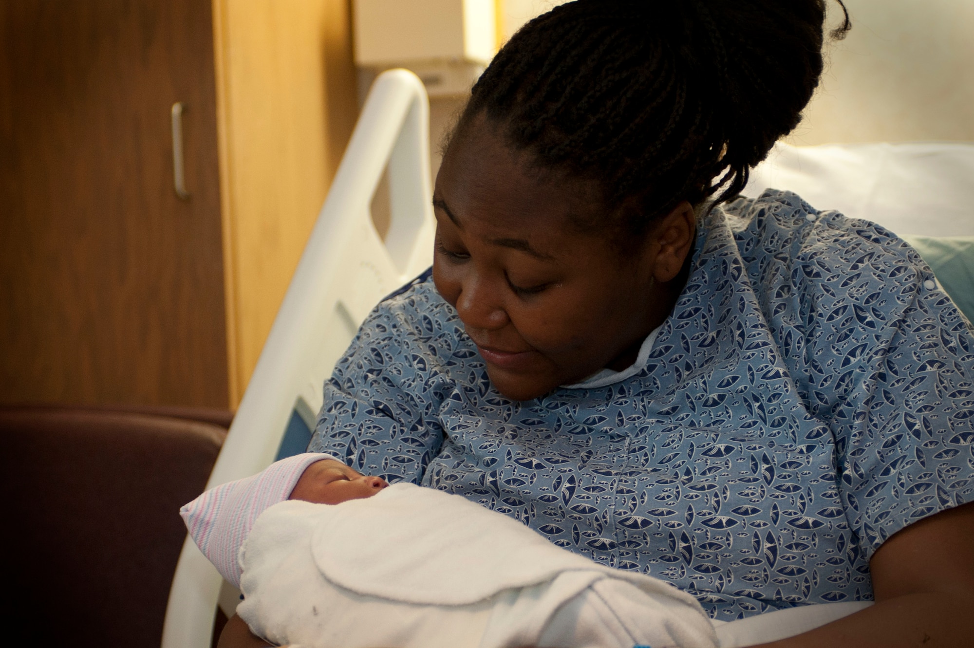Téa Burke holds her newborn daughter, Noélani Burke, at the Mike O'Callaghan Federal Medical Center Jan. 30, 2014, at Nellis Air Force Base, Nev. Noélani was delivered shortly after a disgruntled man brandishing a handgun outside the emergency room caused the hospital to be locked down. (U.S. Air Force photo by Airman 1st Class Timothy Young)