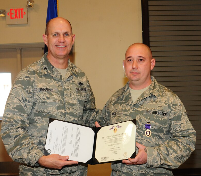 Tech. Sgt. Shawn Hisel awarded Purple Heart for wounds sustained on deployment. Brig. Gen. Johnson, Assistant Adjutant General, Air, presented the award. (U.S. Air Force photo by Staff Sgt. Darrell Hamm/Released)