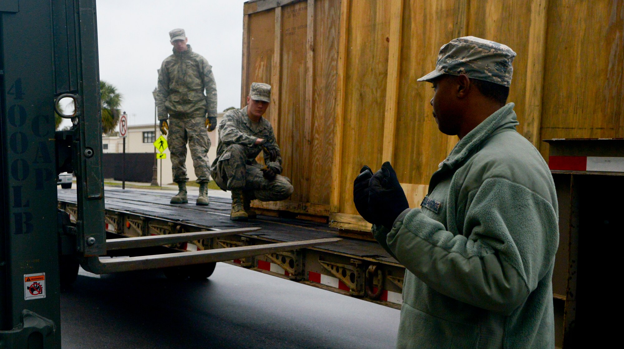 Senior Airman Branden Jones, 6th Logistics Readiness Squadron flight service center, directs a forklift to pick up large aircraft parts at MacDill Air Force Base, Fla., Jan. 30, 2014. Jones and other members of the 6th LRS moved KC-135 Stratotanker parts from a loading dock storage facility to a newly renovated facility inside hangar two to mitigate safety risks. (U.S. Air Force photo by Senior Airman Melissa V. Paradise/Released)