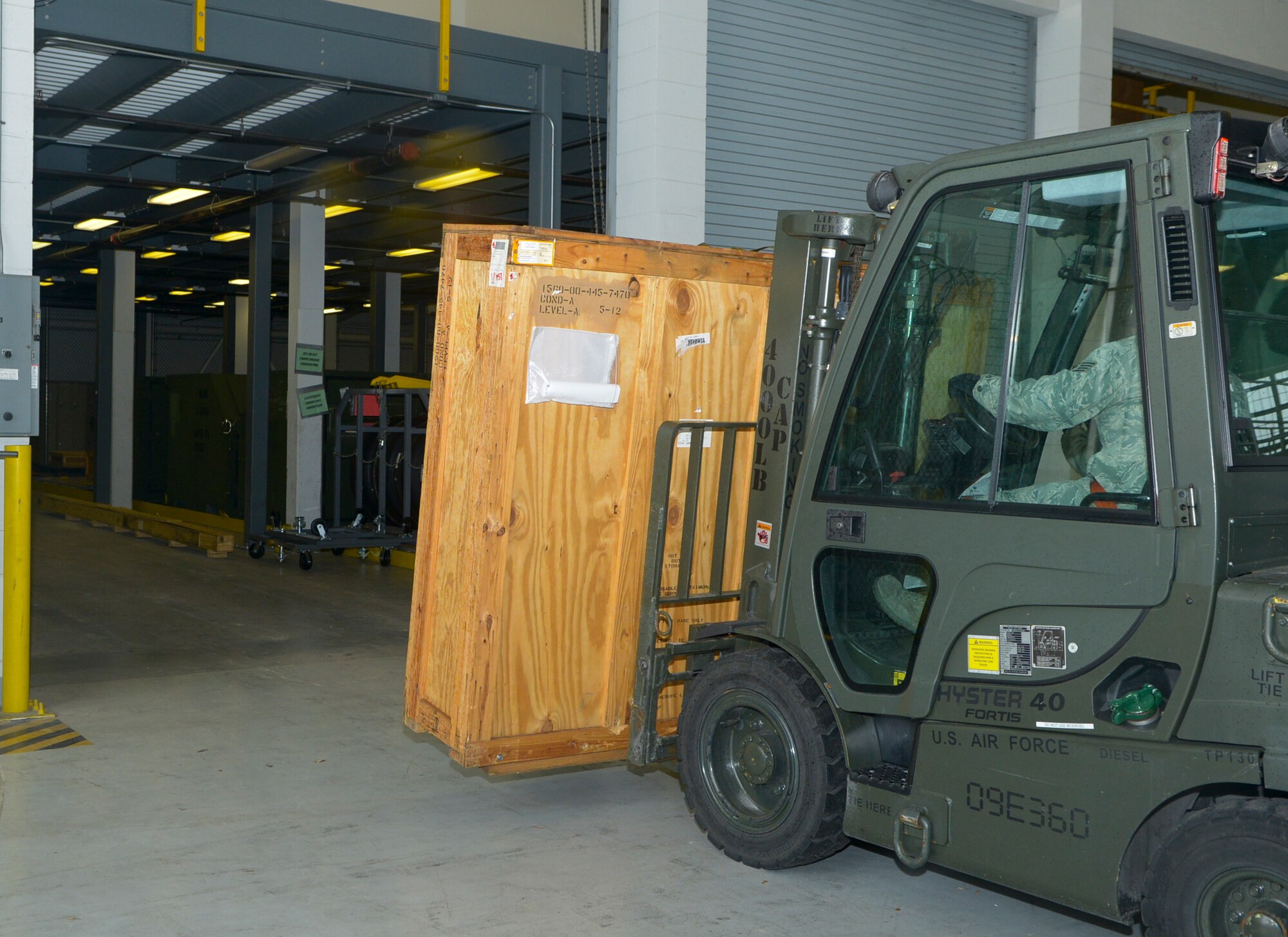 Staff Sgt. Juan Vasquez, 6th Logistics Readiness Squadron NCO in-charge of mobility readiness of spare packages, uses a forklift to put an aircraft part into a new storage facility inside hangar two at MacDill Air Force Base, Fla., Jan. 30, 2014. The move was part of the Air Force Smart Operations for the 21st Century process to prevent mishap and maneuver large aircraft parts with ease. (U.S. Air Force photo by Senior Airman Melissa V. Paradise/Released)  