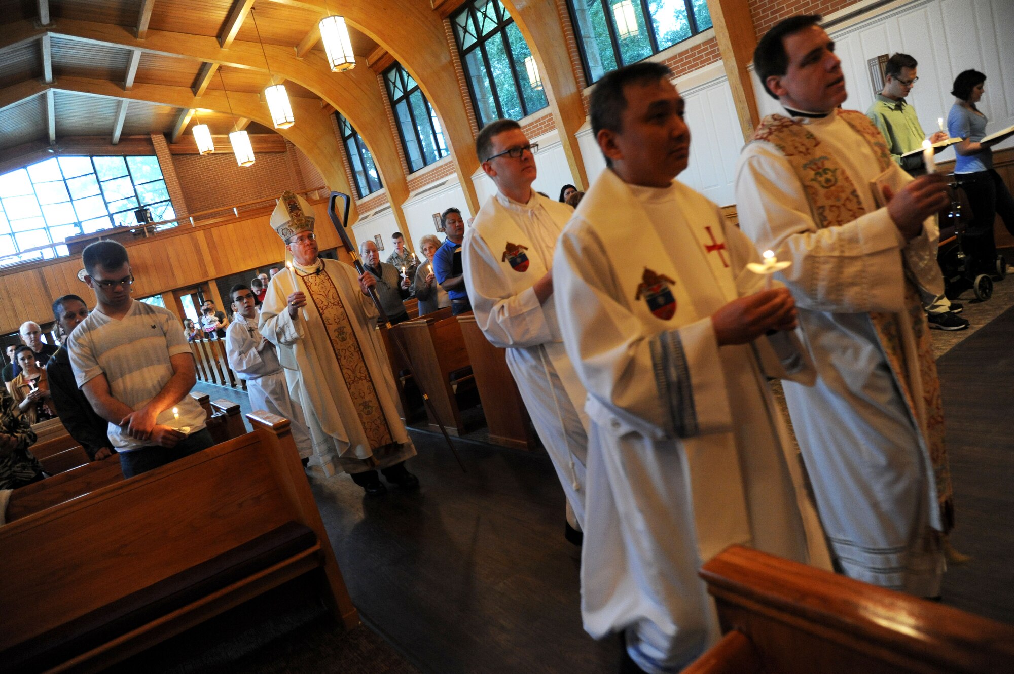 Bishop Neal Buckon, Archdiocese for Military Services, walks down the aisle with his pastoral staff as he leads Keesler’s Catholic Mass, Feb. 2, 2014, at the Triangle Chapel, Keesler Air Force Base, Miss.  Buckon also met with technical training students for prayer and dinner Jan. 31, during his visit to Keesler.  (U.S. Air Force photo by Kemberly Groue)