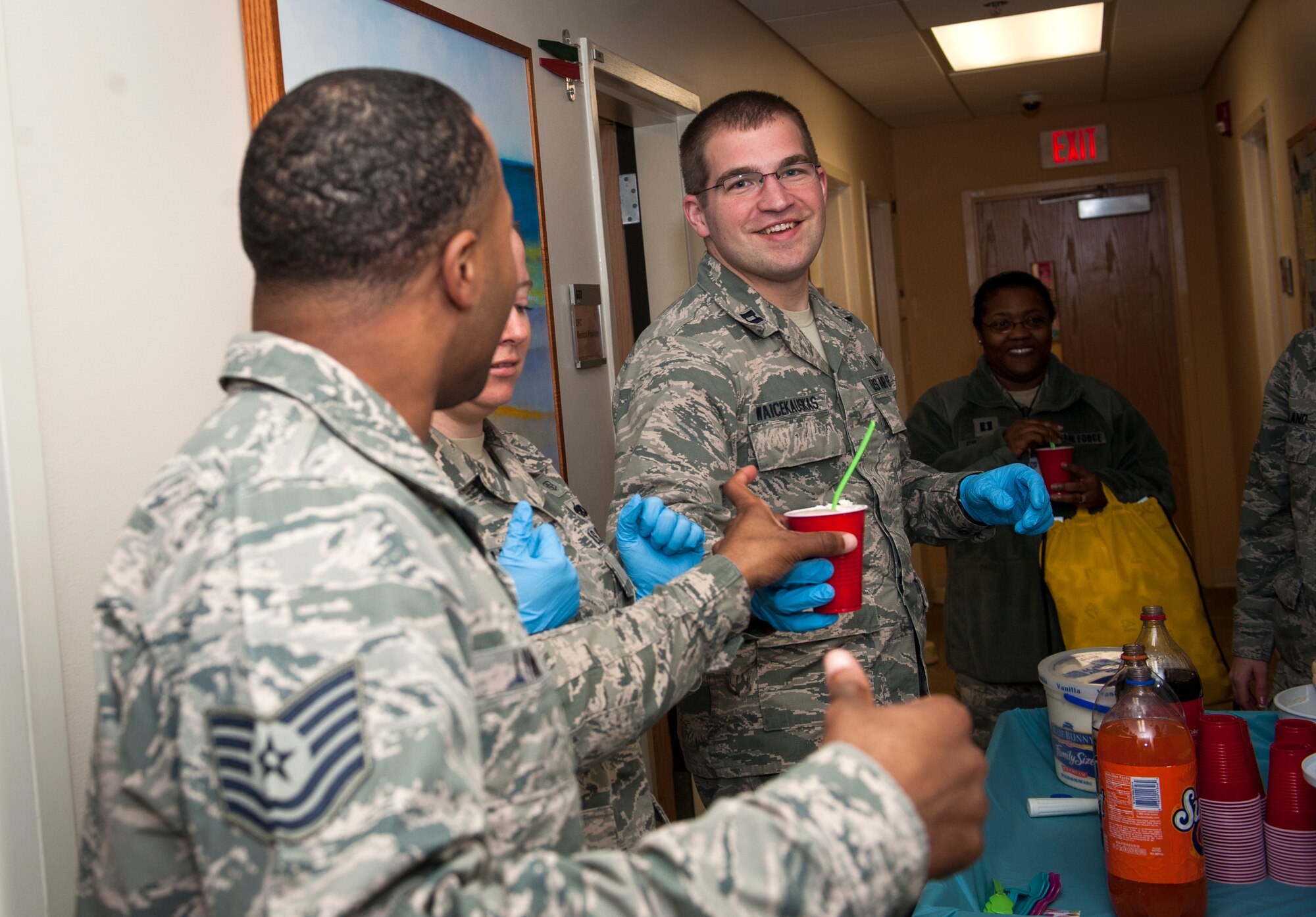 U.S. Air Force Capt. Kevin Waicekauskas, 23d Aerospace Medicine Squadron Bioenvironmental Engineering Flight commander, hands out ice cream floats during Biomedical Science Corps Week at Moody Air Force Base, Ga., Jan. 31, 2014. Handing out floats at the medical facility was one of many events hosted by BSCs and BSC techs throughout the week. (U.S. Air Force photo by Senior Airman Jarrod Grammel/Released)
