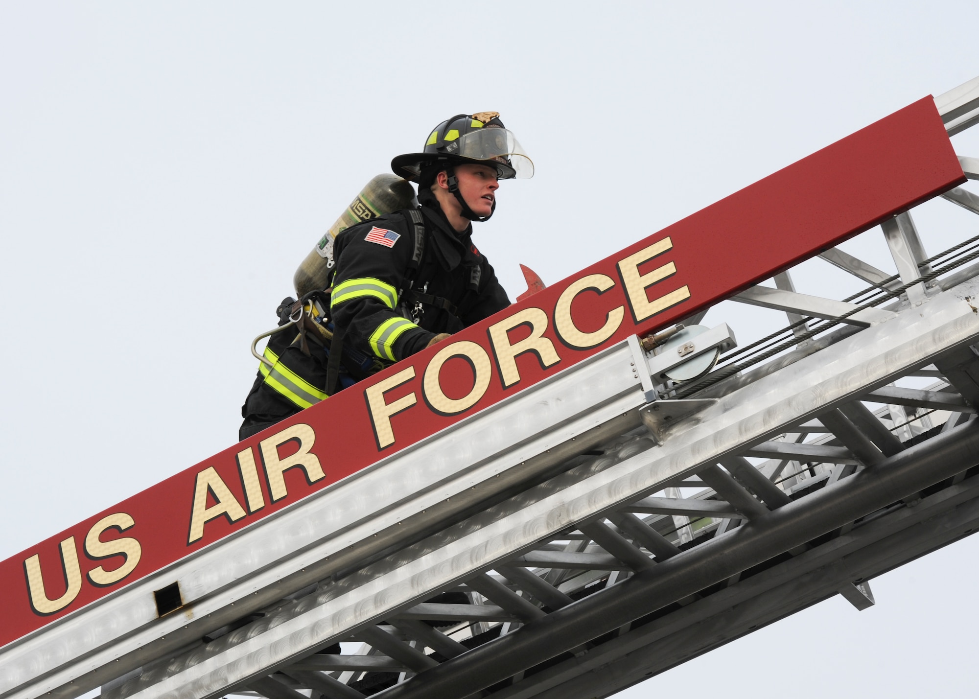 Airman 1st Class Logan Brouse, 436th Civil Engineer Squadron firefighter, climbs up the ladder of a Quint 1 fire truck Jan. 28, 2014, outside of the fire department on Dover Air Force Base, Del. Brouse, a native of Selinsgrove, Pa., has been involved with firefighting activities since the age of 14. (U.S. Air Force photo/Airman 1st Class Zachary Cacicia)