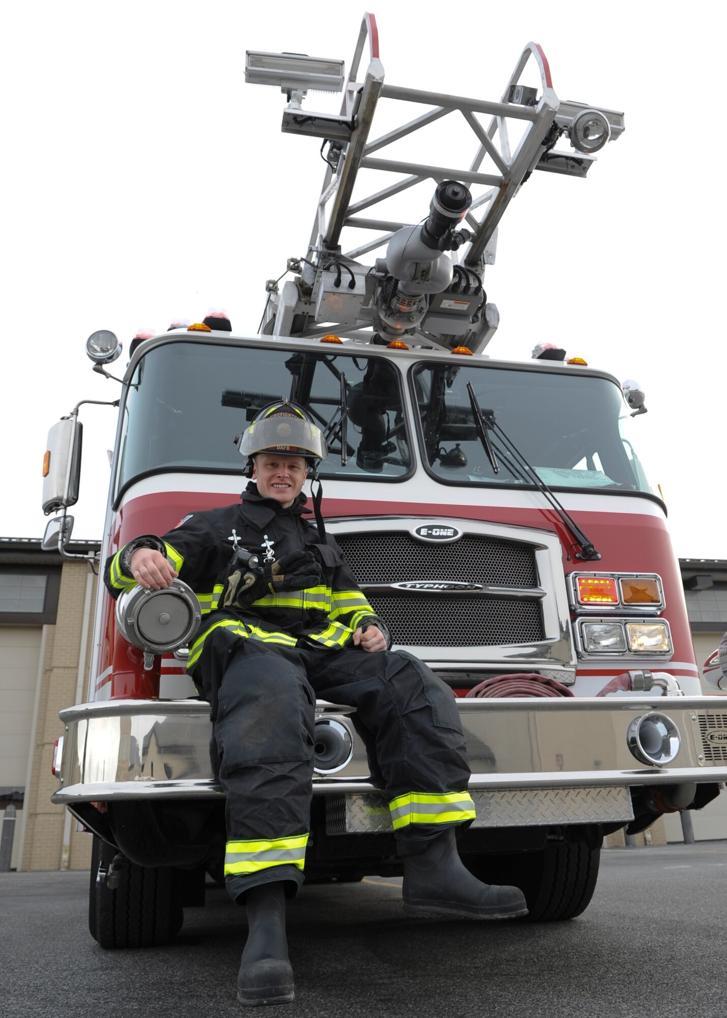 Airman 1st Class Logan Brouse, 436th Civil Engineer Squadron firefighter, sits on the front bumper of a Quint 1 fire truck Jan. 28, 2014, outside of the fire department on Dover Air Force Base, Del. Brouse was selected by his leadership as Airman of the Month. (U.S. Air Force photo/Airman 1st Class Zachary Cacicia)