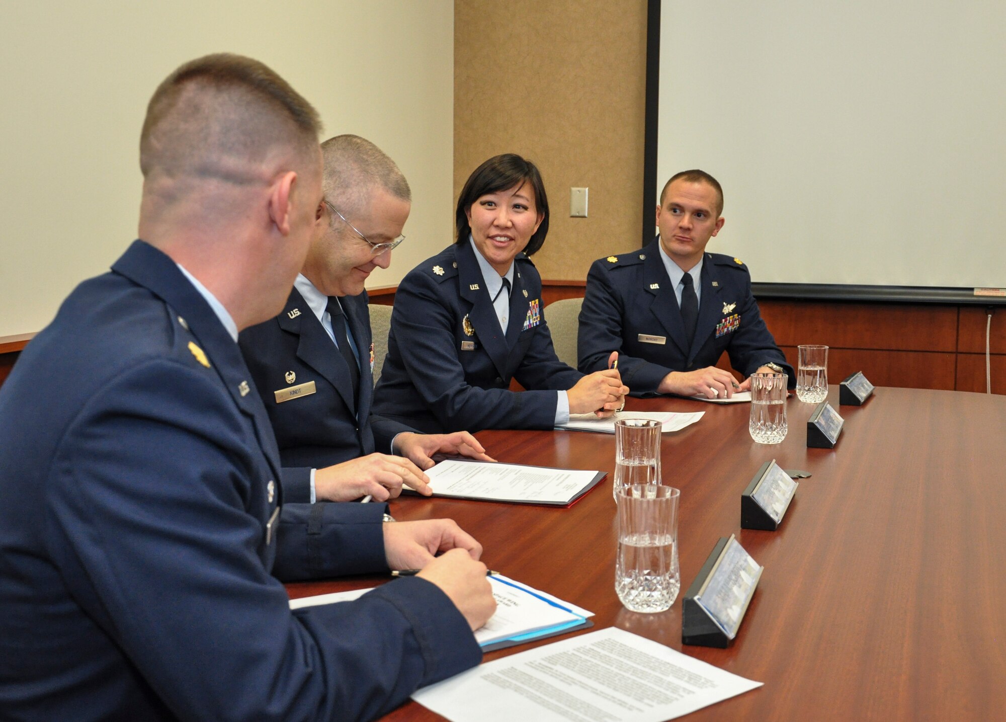 From left, Maj. Nicholas Musgrove, 460th Logistics Readiness Squadron commander; Col. Michael Kindt, 460th Medical Group commander and officer awards board president; Lt. Col. Julie Huygen, 460th Space Wing staff judge advocate; and Maj. Peter Norsky, 460th Operations Group standards and evaluation chief, discuss the annual awards board process Jan. 27, 2014, at the 460th SW headquarters building on Buckley Air Force Base, Colo. All competitors met the annual awards board as part of their overall submission packages. (U.S. Air Force photo by Staff Sgt. Nicholas Rau/Released)